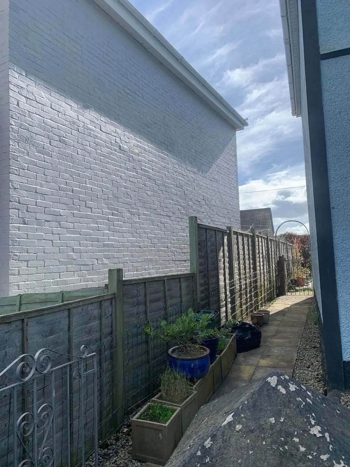 Freshly painted brick wall after preparation and masonry paint in Honiton